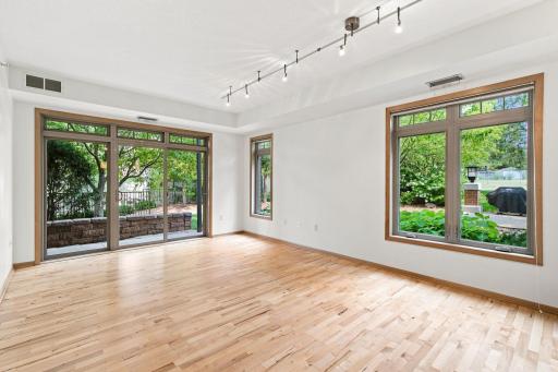Light-filled living room over looking green space