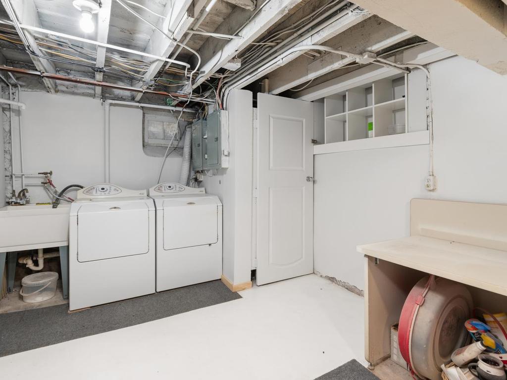 Lower level laundry area for the upper unit.