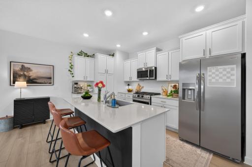 The chef's kitchen if full equipped with stainless steel appliance and a gas stove.