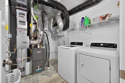upper level laundry room with tankless water heater