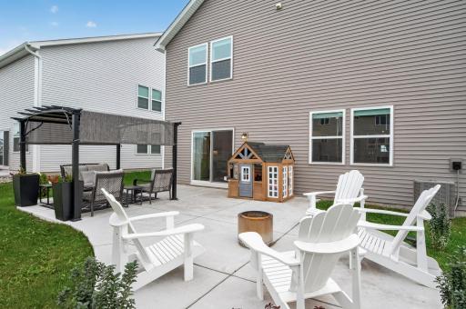 This brand new patio includes a pergola and room for gathering with friends around the bonfire.