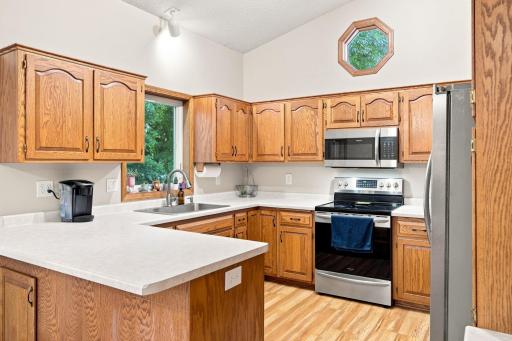 Bright, clean and vaulted kitchen with new sink and dishwasher.