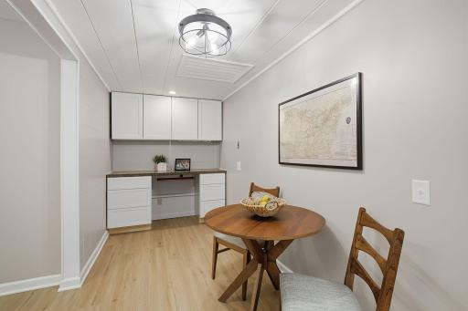 Built-in cabinets & a desk area offer convenient storage just off the kitchen.