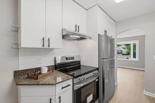 Brand-new range & refrigerator, with cabinetry to keep everything close at hand.