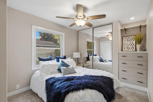 Unwind at the end of the day in this bedroom with mirrored closet doors & a built-in dresser.