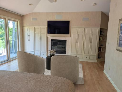 virtual staging to primary bedrooms gas fireplace and built-in storage