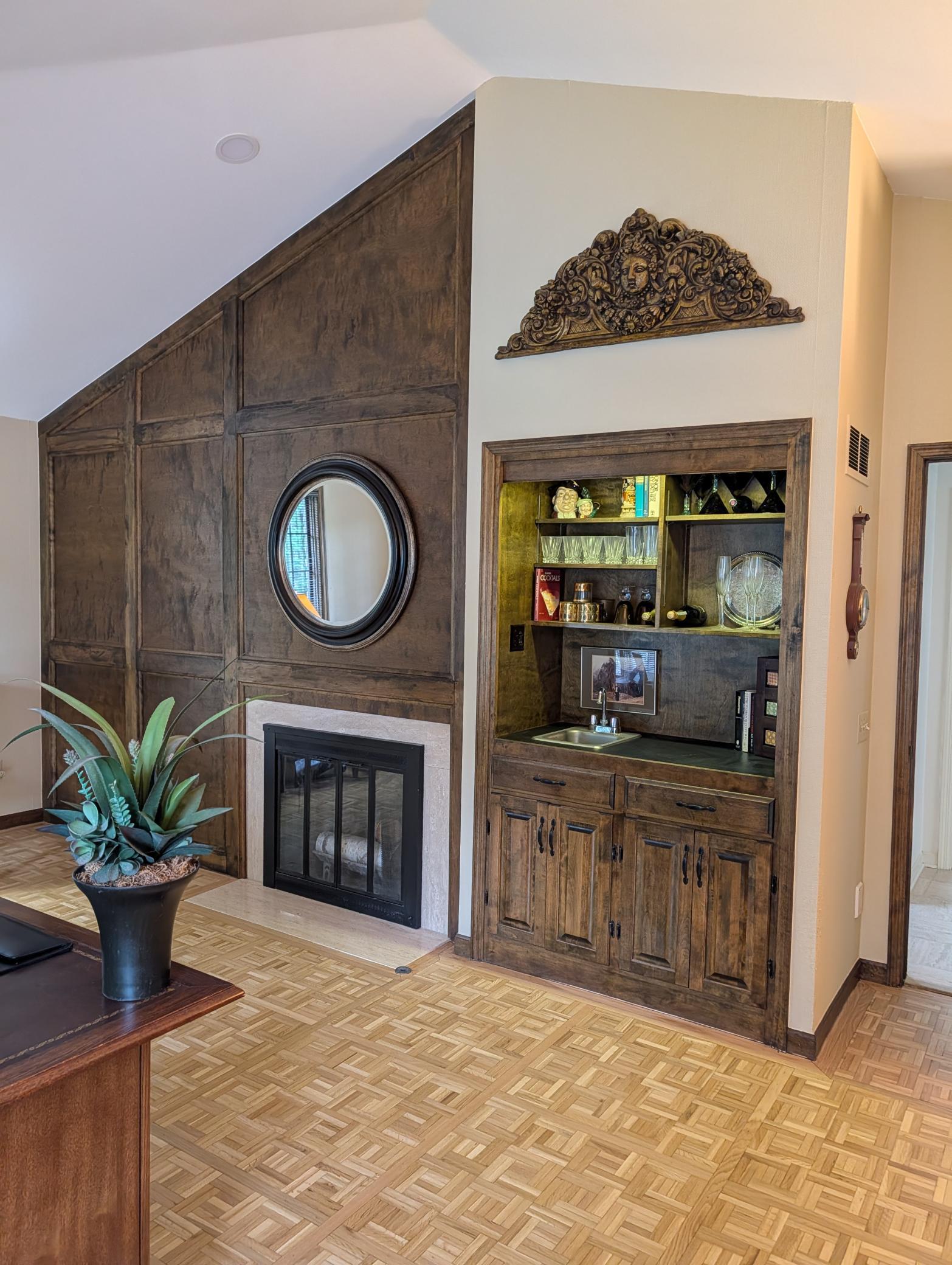 vaulted ceiling main level office/den with wood burning fireplace and wet bar