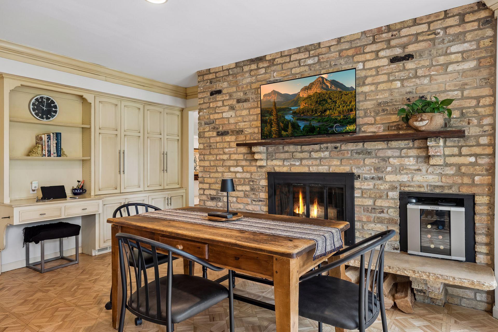 informal dining with wood burning fireplace, work desk and built-in storage