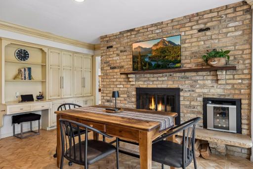 informal dining with wood burning fireplace, work desk and built-in storage