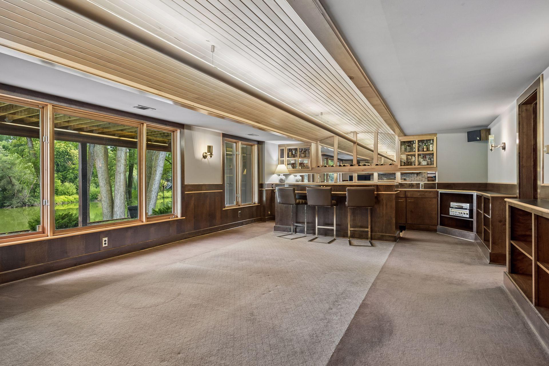 warm wood paneling, a barrel-vaulted ceiling and custom shelving with ample display space