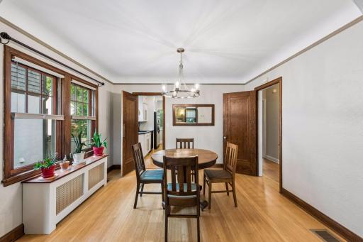 The formal dining room also features all new thermal pane windows, original hardwood flooring, natural woodwork and coved ceilings.