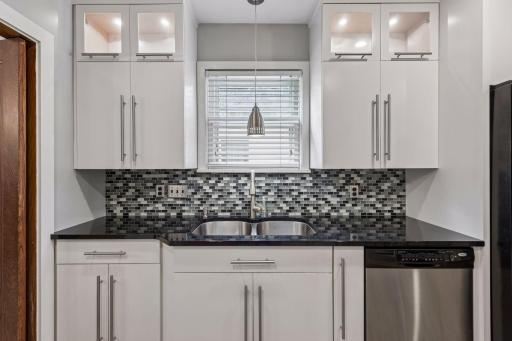 View of kitchen sink area with tiled backsplash, newer windows
