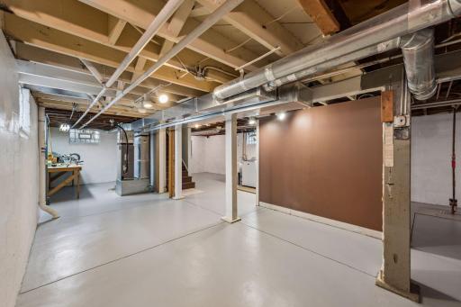 Another view of basement with workshop area and bench.
