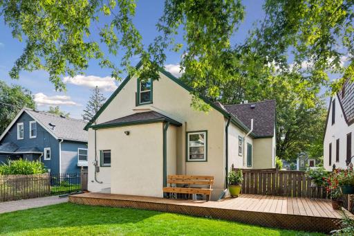 Another view of back of the house and deck, also features wood fencing full in back yard.