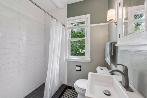 Main floor 3/4 bathroom has been remodeled to a walk-in shower, all new wall tile, toilet, vanity, sink, faucet and lighting. Beautiful original tiled flooring.