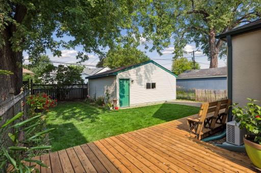 Another view of back yard, garage and deck.