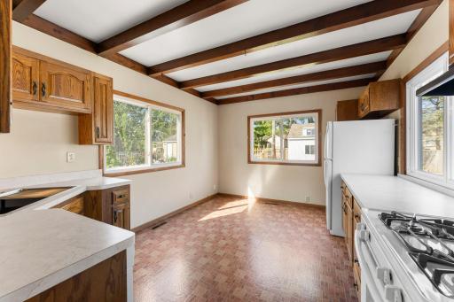 Kitchen features tons of windows, large footprint, and eating area.