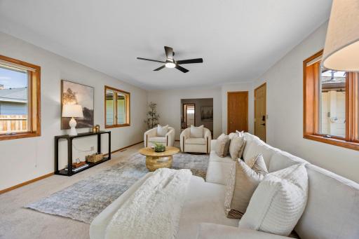 It is a huge, light-filled space with brand-new plush carpet (2026), windows across multiple walls, and south-facing exposure that keeps the room bright throughout the day before bringing in beautiful evening light.