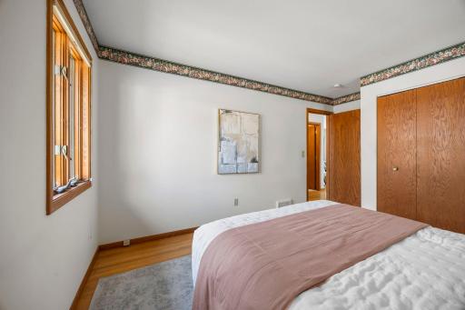 The primary bedroom has great space, peaceful backyard views, and dual closets.
