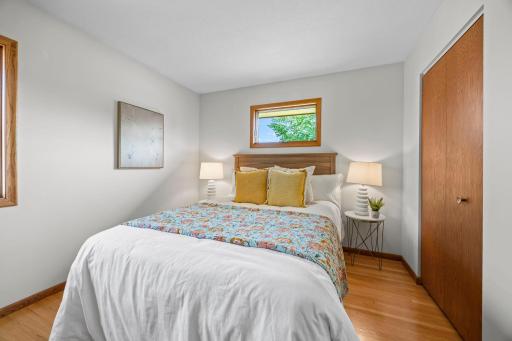 The second bedroom adds a fun touch with its wood-paneled accent wall.