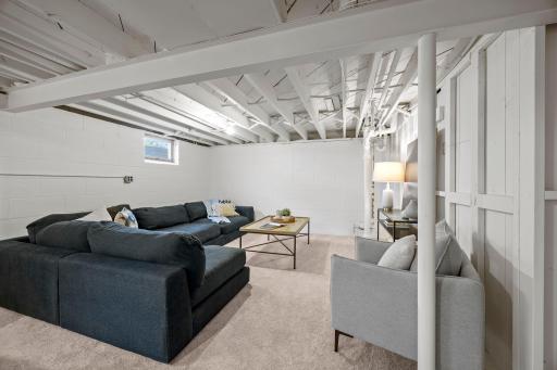 Fresh paint and new carpet (2026) carry throughout the spacious recreation room and adjoining bonus room.