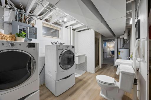Along with a bright, finished laundry area featuring Maytag washer and dryer and utility sink.