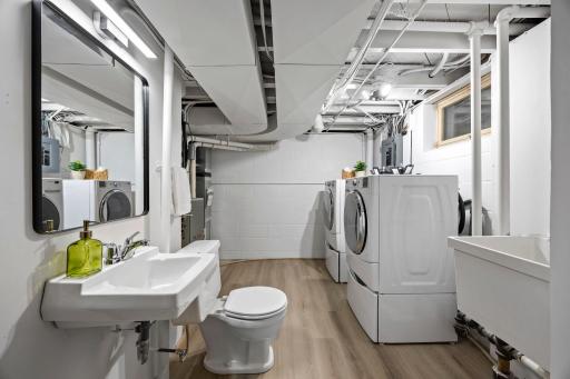 A second bathroom with a walk-in shower and new LVT flooring (2026) is nearby.