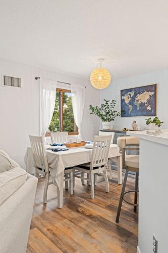 Dedicated dining space with a large window, stylish pendant lighting, and convenient proximity to the kitchen.