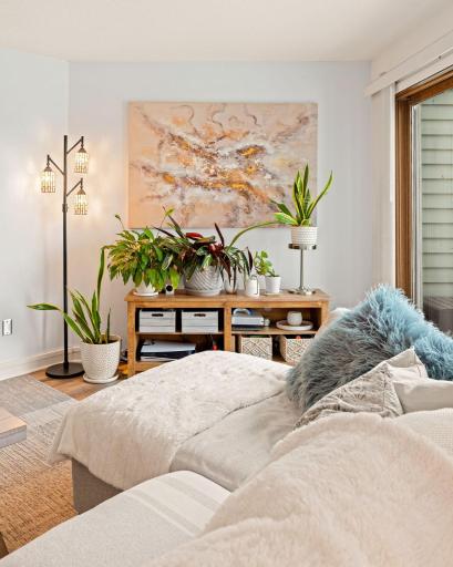 Inviting living room corner filled with natural light, offering plenty of space for dÃ©cor, plants, and additional storage near the private balcony.