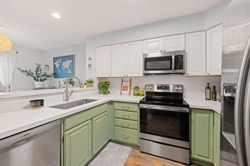 Well-appointed kitchen with stainless-steel range and microwave, abundant cabinet storage, and generous countertop workspace.
