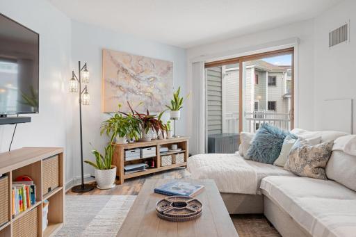 Comfortable living space highlighted by large sliding glass doors that bring in natural light and provide balcony access.