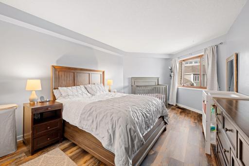 Spacious primary bedroom with room for a large bed and additional furnishings, plus a generous window providing natural light.