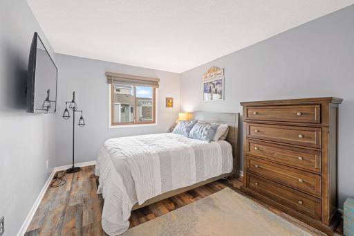 Comfortable second bedroom with a large window, and plenty of room for bedroom furniture or a home office setup.