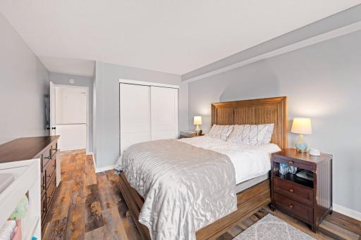 Additional view of the primary bedroom showcasing ample floor space and a wide closet with sliding doors.
