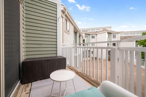 Another view of the private balcony showcasing its usable seating space and open courtyard setting.