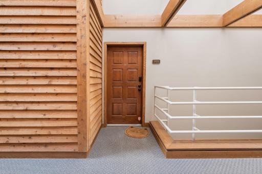 Private entrance to Unit 305 located along the buildingâs bright, architecturally distinctive interior walkway.