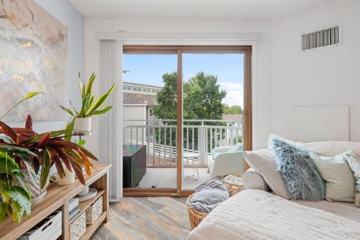 Sliding glass doors open from the living room to the private balcony, extending the living space outdoors.