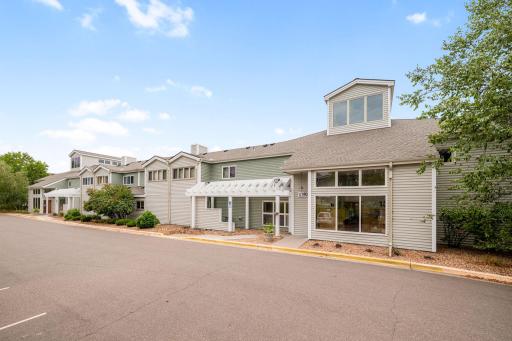 Exterior view showcasing the communityâs distinctive architecture, multiple entrances, and landscaped surroundings.