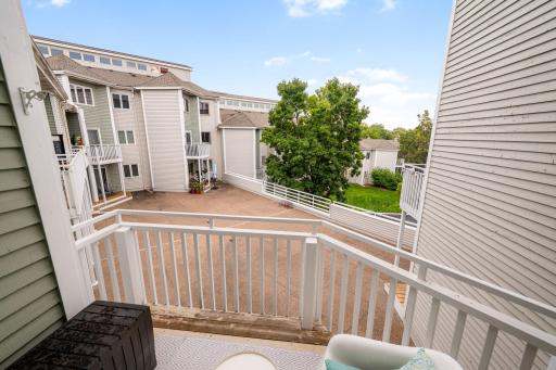 Elevated balcony overlooking the landscaped courtyard and surrounding Maclaren Hill community.