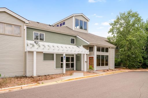Welcoming exterior entrance to the Maclaren Hill Condominiums with covered entry and mature landscaping.