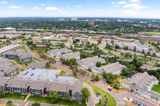Aerial view highlighting the communityâs convenient St. Paul location with nearby shopping, services, major roadways, and surrounding neighborhoods.