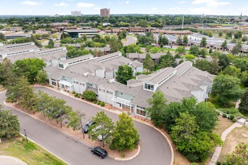 Elevated aerial view showcasing the condominium complex, landscaped grounds, and convenient access to the surrounding St. Paul area.