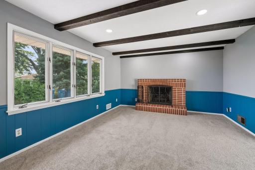 Second main floor living room with wood fireplace.