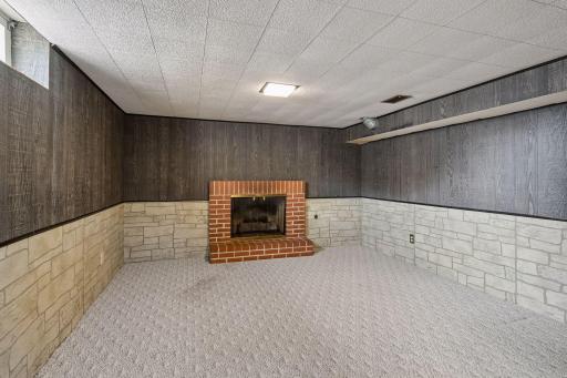 Second downstairs living room with woodburning fireplace.
