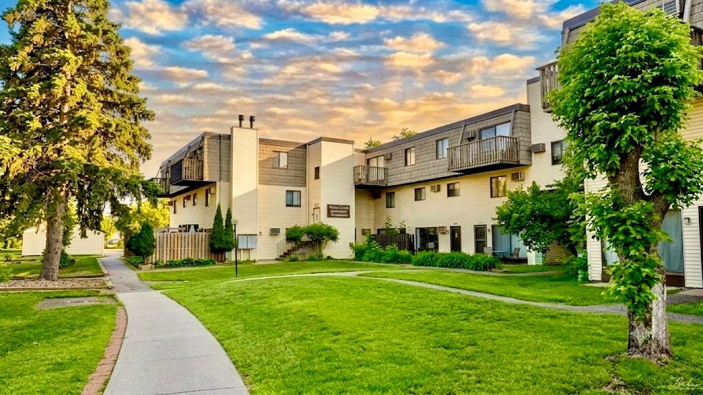 Charming multi-unit building surrounded by lush green landscaping and mature trees curb appeal that makes a strong first impression.