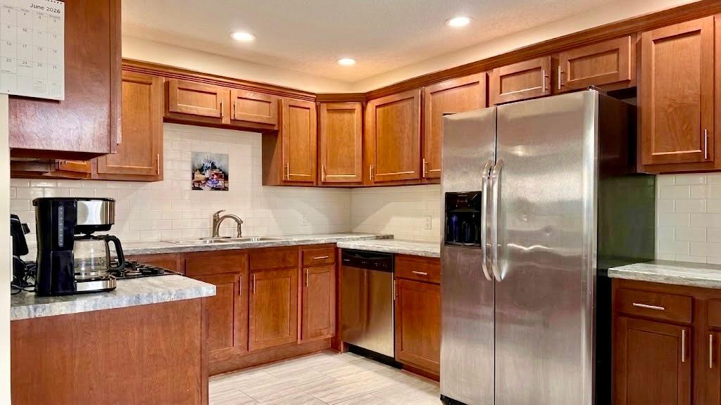 Fully equipped kitchen featuring warm wood cabinetry, stainless steel appliances, and ample counter space ready for everything from morning coffee to dinner parties.