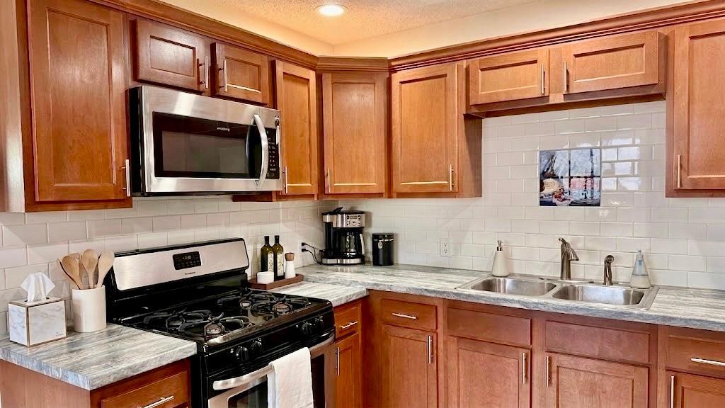 Clean, functional layout with white appliances and bright finishes, efficient use of space that keeps daily living simple and organized.