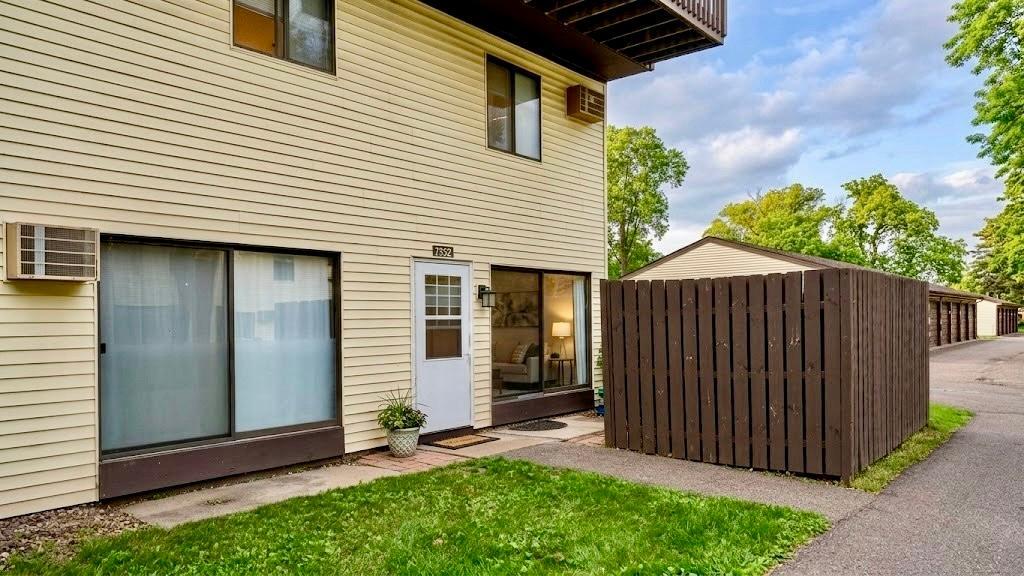 Private entry with a covered outdoor space and wood fencing a quiet corner to unwind after a long day.
