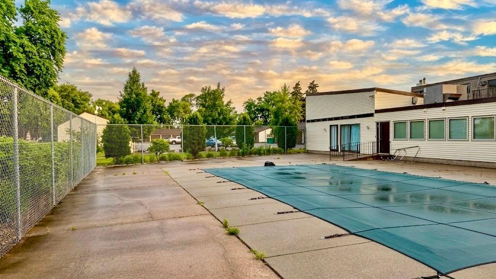 Community Pool Sparkling community pool set against a beautifully maintained lawn summer living doesn't get better than this.