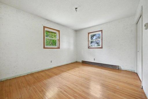 Primary bedroom has hardwood floors and ready to finish